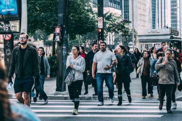 A lot of pedestrians crossing the road.