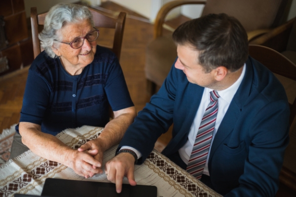 An elderly woman with a lawyer discussing possible elder abuse in nursing homes.