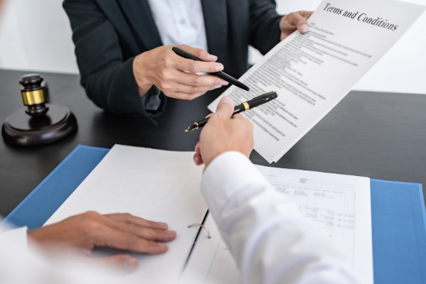 A lawyer explaining the legalities of the medical malpractice case to her client.