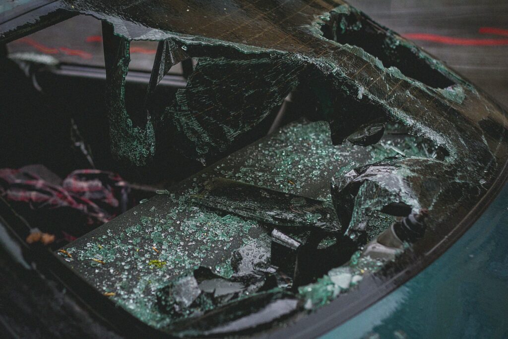 a closeup of a broken car windshield after a motor vehicle accident