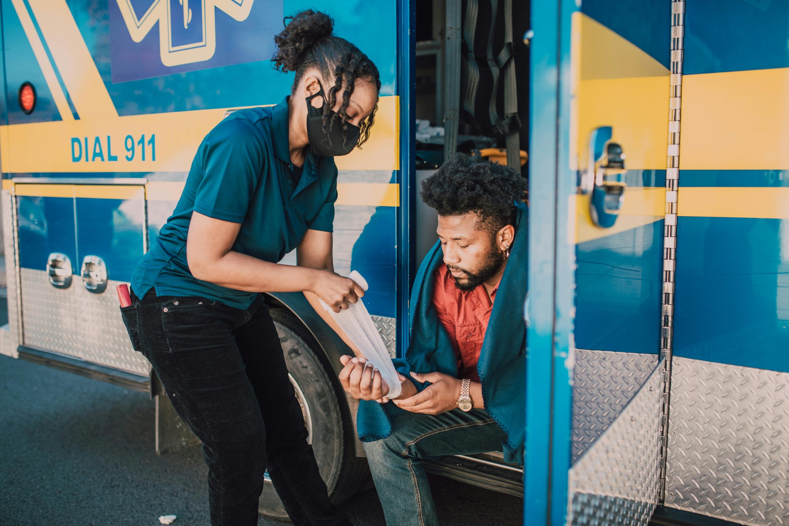 a first responder giving first aid to a personal injury victim