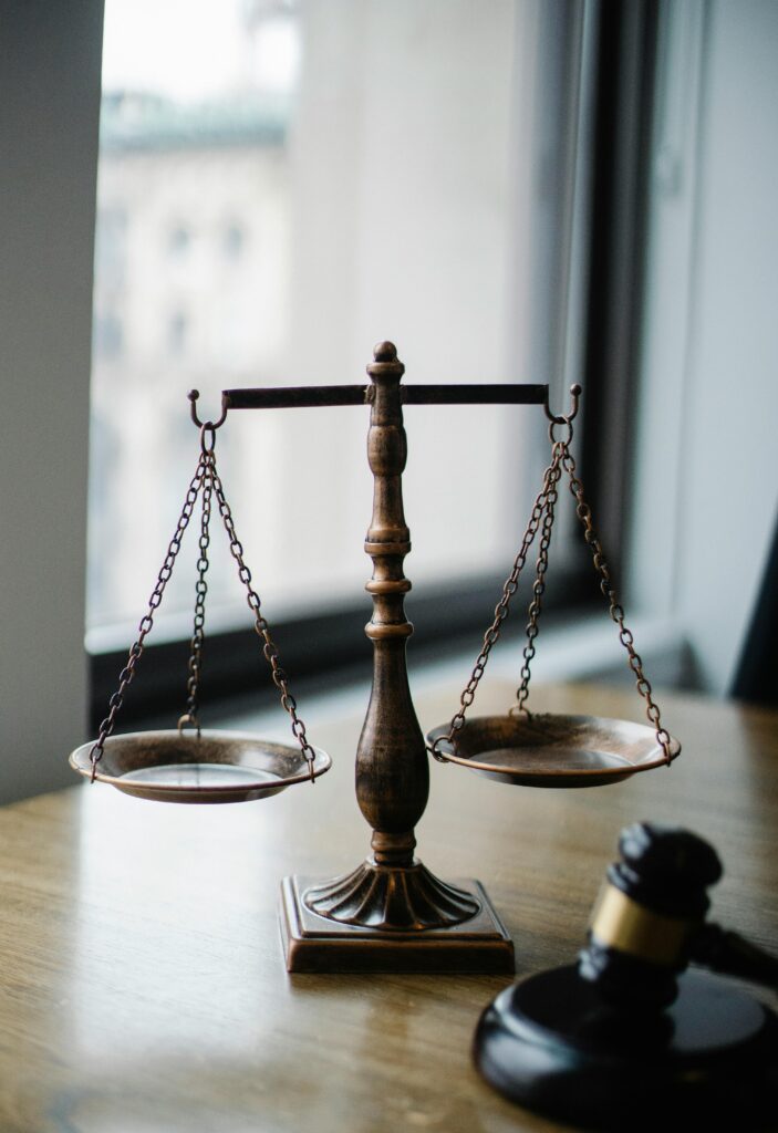 a scale of justice and gavel sitting on a desk at a law firm